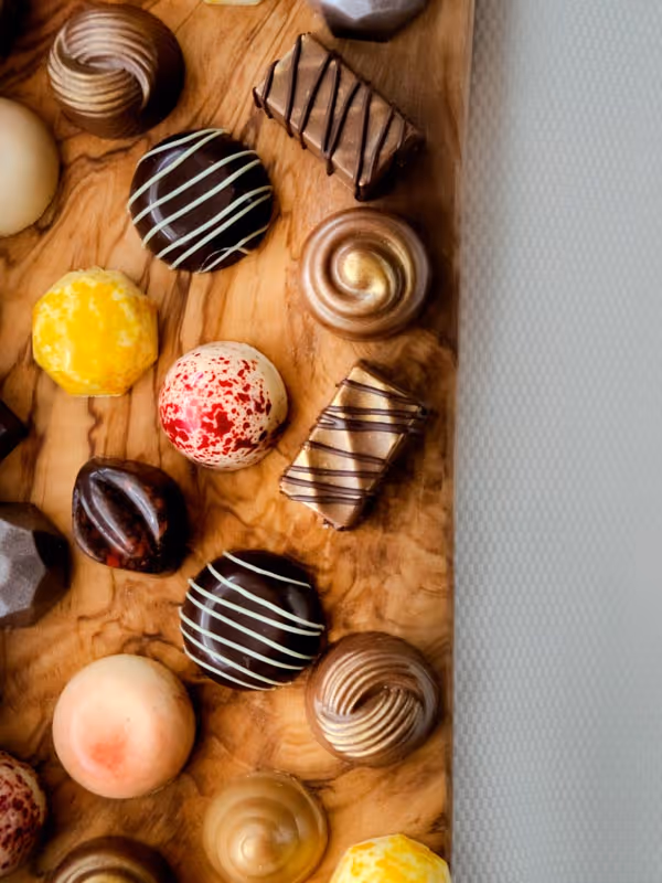 bovenaanzicht van een plank vol belgische chocolade bonbons