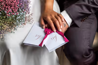 Close up van handen bruidspaar met geloftenboekjes